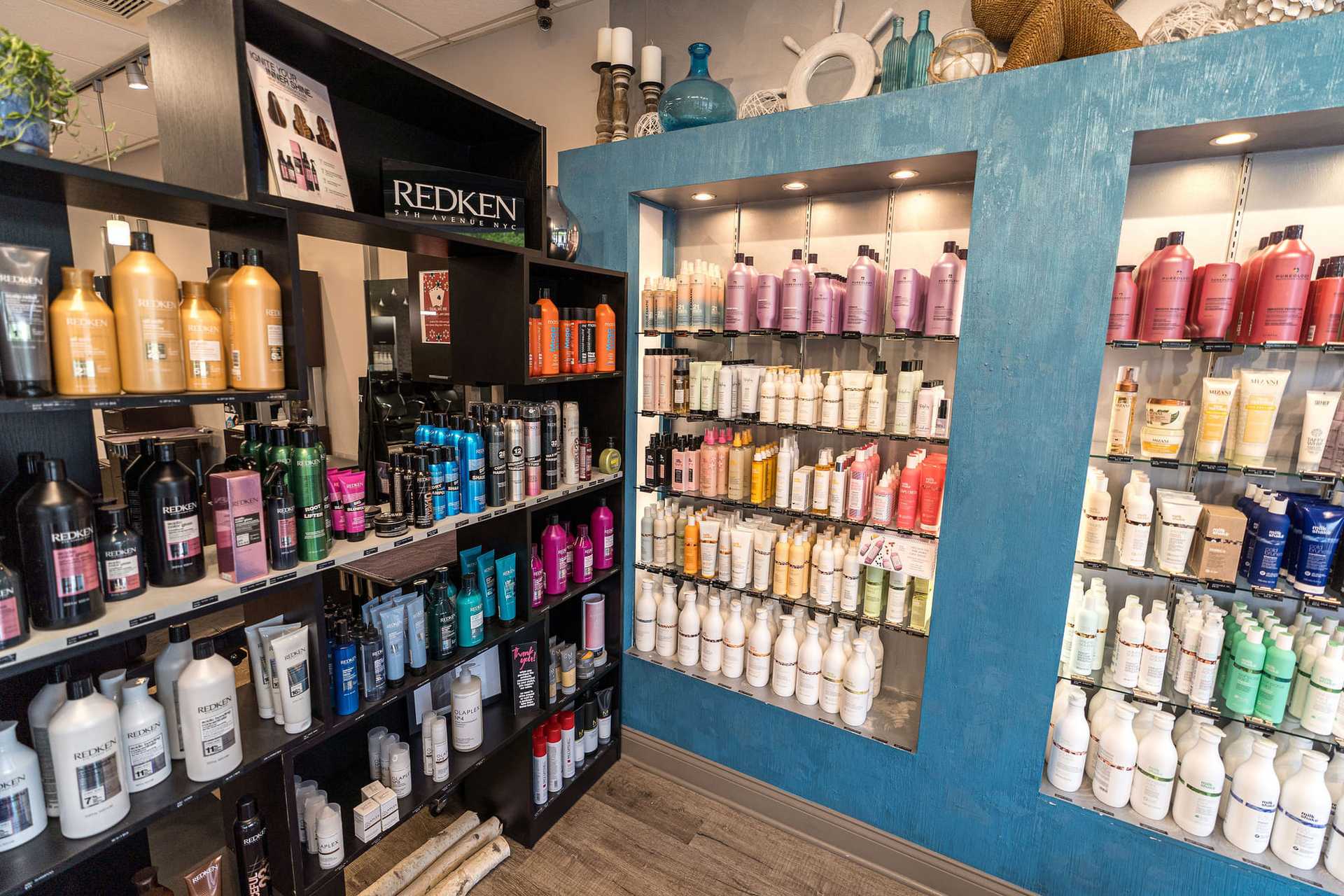 Shelves of various hair care products displayed in a brightly lit store section.