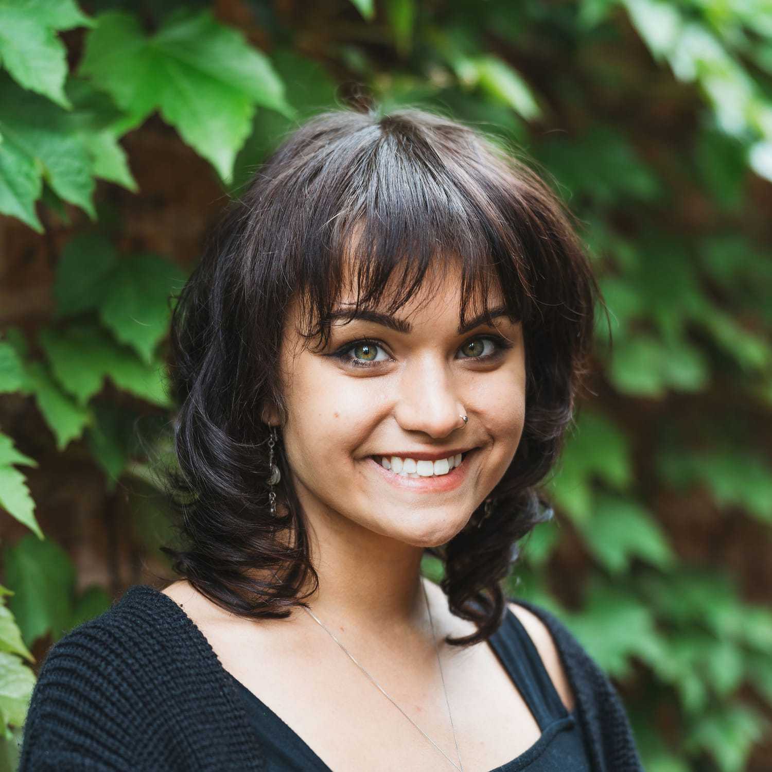Portrait of Jennifer, a professional stylist at Anasa Salon, showcasing their expertise and style.